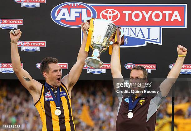 Luke Hodge and Alastair Clarkson the coach of the Hawks hold up the Premeirship Cup during the 2014 AFL Grand Final match between the Sydney Swans...