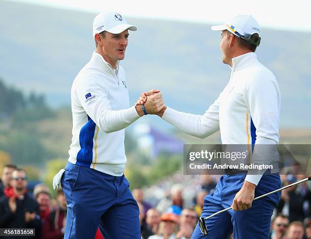 Justin Rose and Henrik Stenson of Europe celebrate on the 13th green during the Morning Fourballs of the 2014 Ryder Cup on the PGA Centenary course...