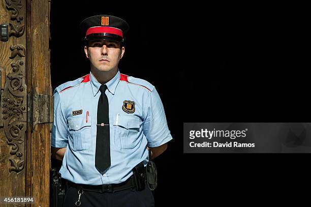 Mosso d'Esquadra officer, the Catalan Police, stand guard at the main entrance of the Palau de la Generalitat, the Catalan government building, on...
