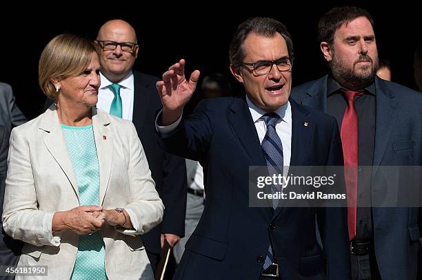 President of Catalonia Artur Mas waves as he leaves the Palau de la Generalitat, the Catalan government building, next to President of the Parliament...