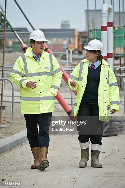 Prime Minister David Cameron with assistant site manager Gemma Goddard during a visit to the new Taylor Wimpy Great Western Park housing estate on...