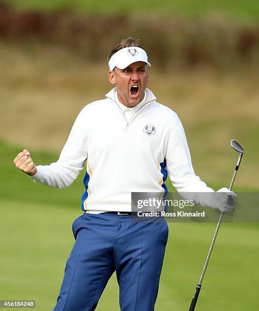 Ian Poulter of Europe celebrates chipping in on the 15th hole during the Morning Fourballs of the 2014 Ryder Cup on the PGA Centenary course at the...