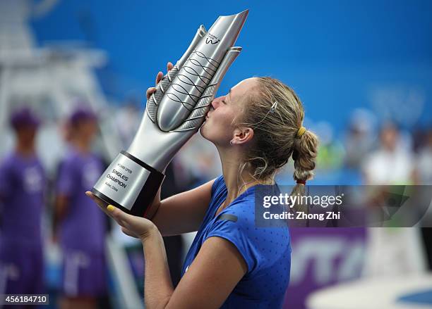 Petra Kvitova of Czech victorious with trophy after winning her final match against Eugenie Bouchard of Canada on day seven of 2014 Dongfeng Motor...