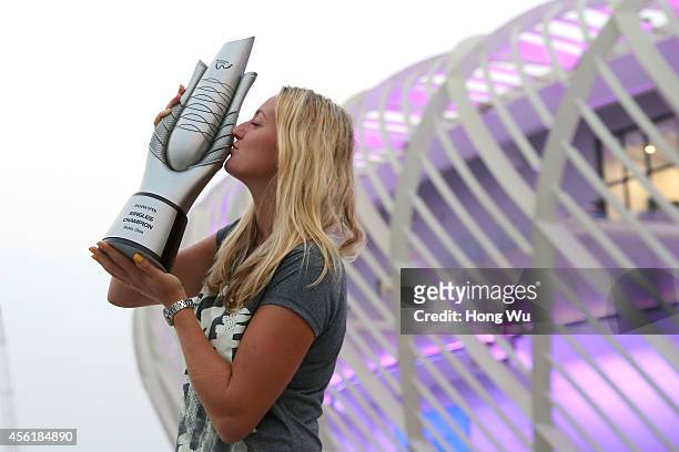 Petra Kvitova of Czech Republic kisses the trophy to celebrate after winning the final match against Eugenie Bouchard of Canada on day seven of 2014...