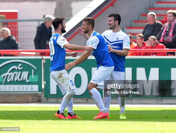 Marcel Heller, Tobias Kempe and Jerome Gondorf of SV Darmstadt 98 celebrate after scoring the 0:1 during the game between 1 FC Union Berlin and SV...