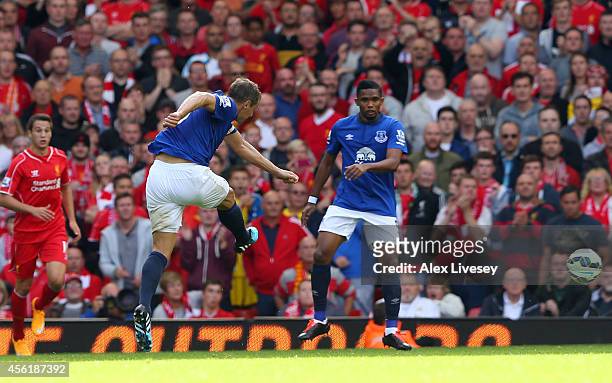 Phil Jagielka of Everton scores a late goal to level the scores at 1-1 during the Barclays Premier League match between Liverpool and Everton at...