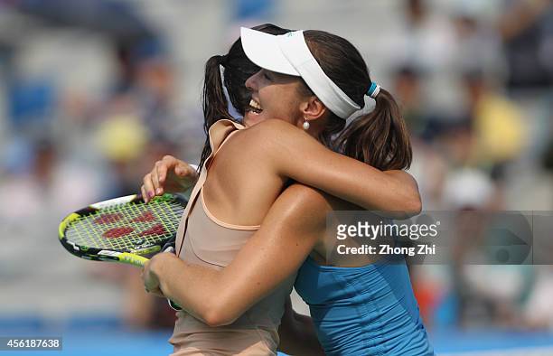 Martina Hingis of Switzerland and Flavia Pennetta of Italy react after winning their doubles final match against Cara Black of Zimbabwe and Caroline...
