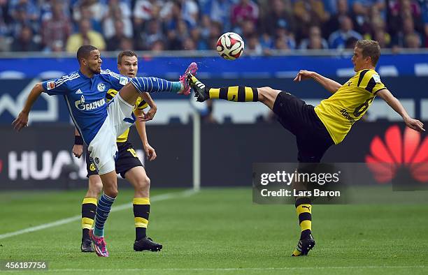 Sidney Sam of Schalke is challenged by Sven Bender of Dortmund during the Bundesliga match between FC Schalke 04 and Borussia Dortmund at Veltins...