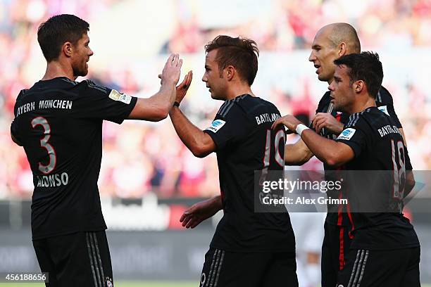 Mario Goetze of Muenchen celebrates his team's first goal with team mates Xabi Alonso, Arjen Robben and Juan Bernat during the Bundesliga match...