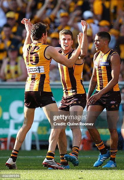 Luke Breust of the Hawks is congratulated by Isaac Smith after kicking a goal during the 2014 AFL Grand Final match between the Sydney Swans and the...