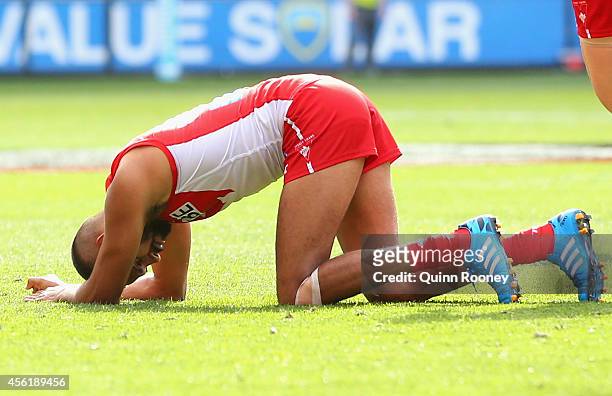 Lewis Jetta of the Swans goes down hurt after colliding with Ben McEvoy of the Hawks during the 2014 AFL Grand Final match between the Sydney Swans...