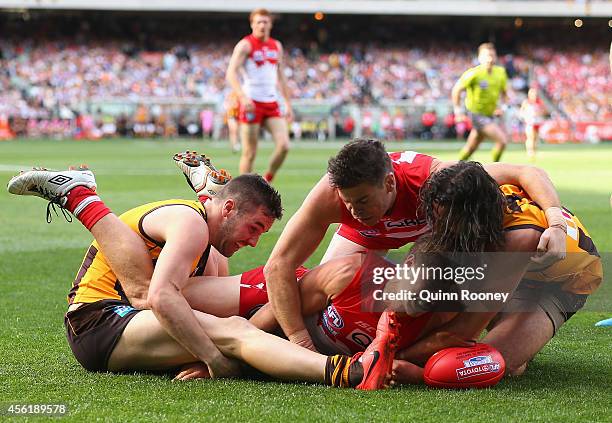 Matt Suckling and Matt Spangher of the Hawks compete for a ball against Kieren Jack and Craig Bird of the Swans during the 2014 AFL Grand Final match...