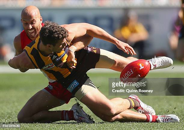 Ben Stratton of the Hawks is tackled by Jarrad McVeigh of the Swans during the 2014 AFL Grand Final match between the Sydney Swans and the Hawthorn...