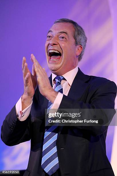 Party leader Nigel Farage, cheers and applauds as Conservative MP Mark Reckless arrives on stage to announce he was defecting from the tories on the...