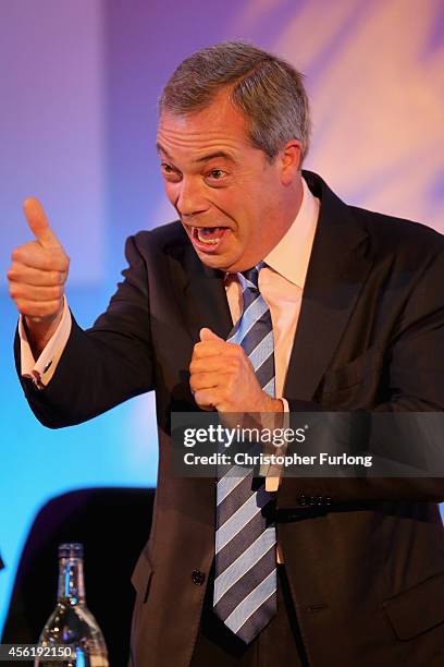 Party leader Nigel Farage, cheers and applauds as Conservative MP Mark Reckless arrives on stage to announce he was defecting from the tories on the...