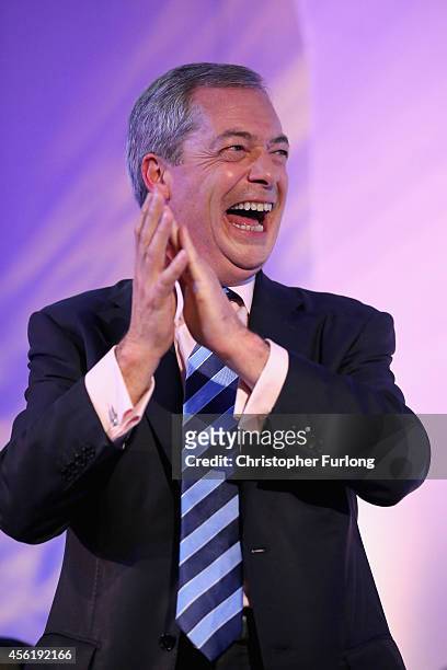 Party leader Nigel Farage, cheers and applauds as Conservative MP Mark Reckless arrives on stage to announce he was defecting from the tories on the...