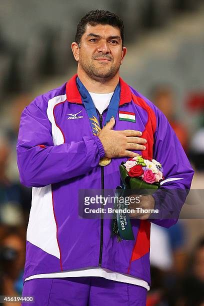 Gold medalist, Dilshod Nazarov of Tajikistan stands for his nations national anthem following the Men's Hammer Throw Final during day eight of the...