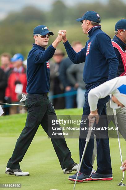 Matt Kuchar and Zach Johnson of the United States fist bump on eight during the foursome matches for the 40th Ryder Cup at Gleneagles, on September...