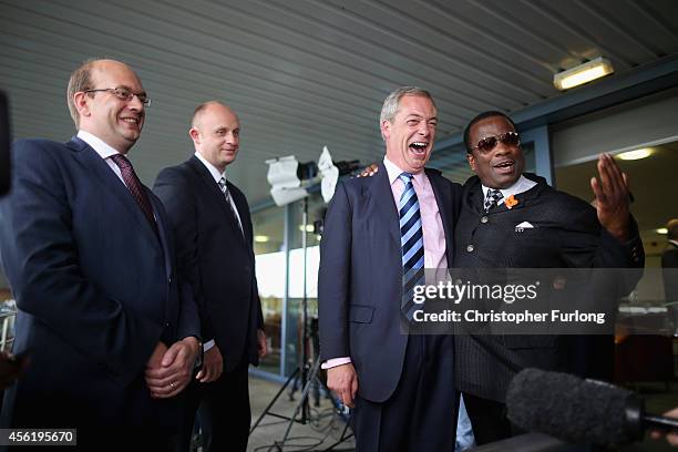 Conservative MP Mark Reckless and UKIP party leader Nigel Farage are congratulated by delegate Winston McKenzie after the tory MP announced he was...