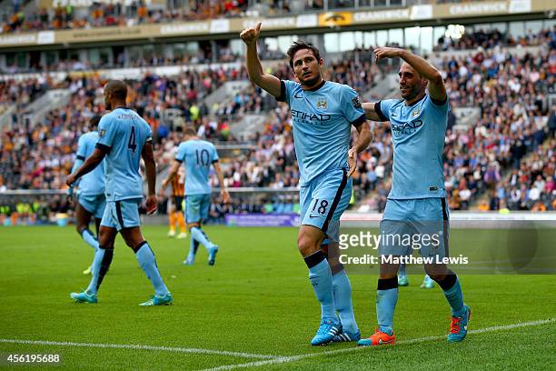 Frank Lampard of Manchester City celebrates with team-mate Pablo Zabaleta after scoring his team's fourth goal during the Barclays Premier League...