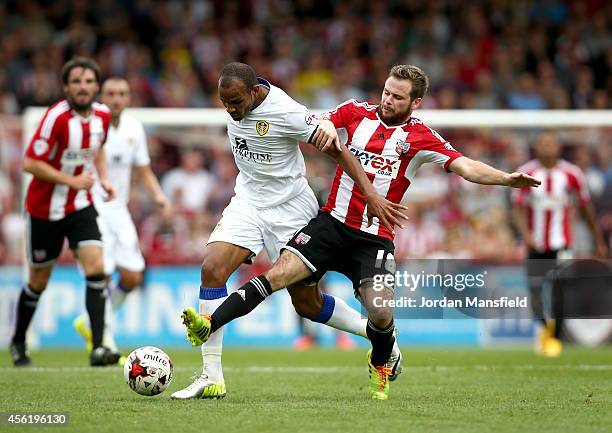 Alan Judge of Brentford tackles Rodolph Austin of Leeds during the Sky Bet Championship match between Brentford and Leeds United at Griffin Park on...