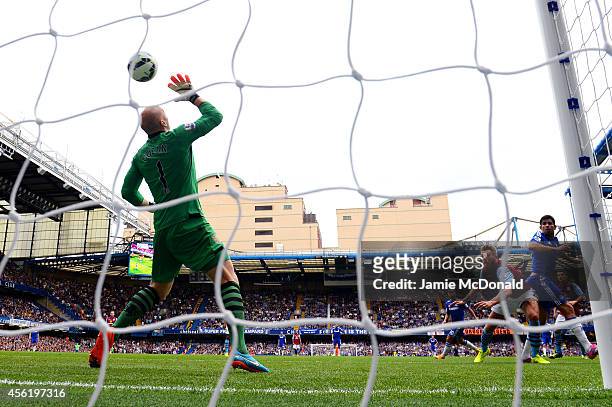 Diego Costa of Chelsea scores his team's third goal past goalkeeper Brad Guzan of Aston Villa during the Barclays Premier League match between...