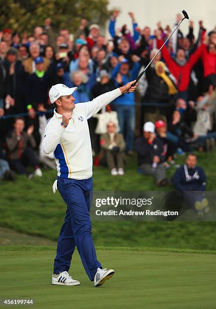 Justin Rose of Europe celebrates as he halves his match on the 18th green during the Afternoon Foursomes of the 2014 Ryder Cup on the PGA Centenary...