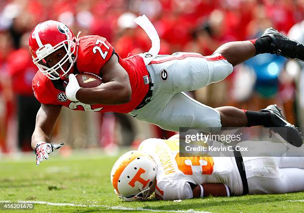 Nick Chubb of the Georgia Bulldogs dives for a touchdown over Brian Randolph of the Tennessee Volunteers at Sanford Stadium on September 27, 2014 in...