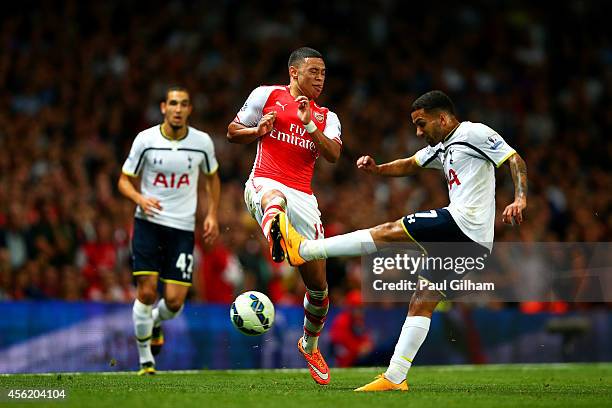 Alex Oxlade-Chamberlain of Arsenal attempts to block a clearance from Aaron Lennon of Spurs during the Barclays Premier League match between Arsenal...