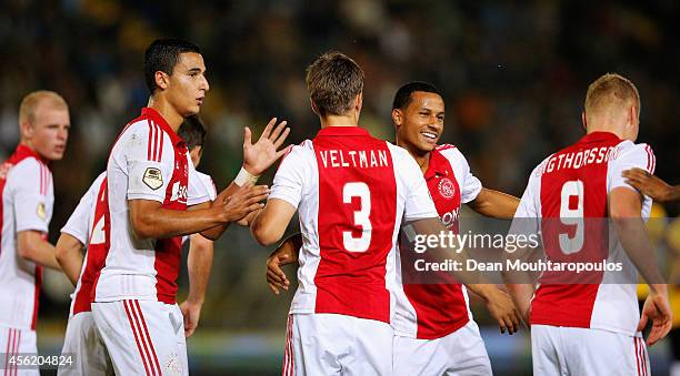 Joel Veltman of Ajax is congratulated after he shoots and scores a goal with team mates during the Dutch Eredivisie match between NAC Breda and Ajax...