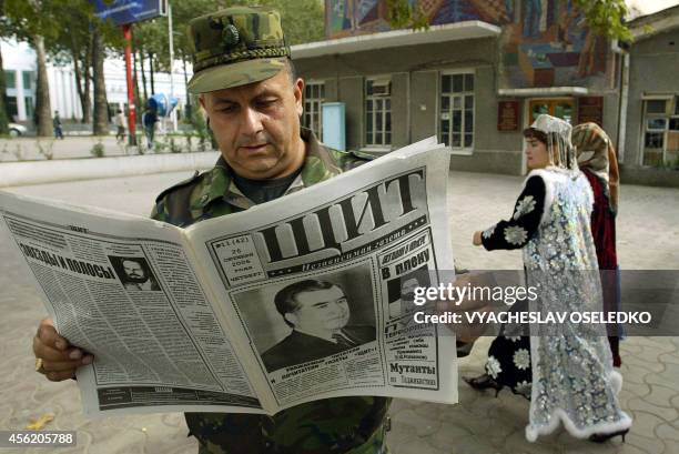 Tajik military officer reads a newspaper, featuring President Emomali Rakhmonov on the front page, in Dushanbe, 28 October 2006. Rakhmonov, who is...