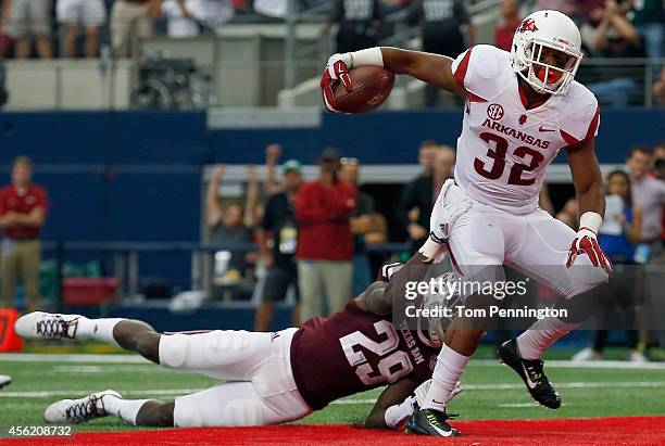 Jonathan Williams of the Arkansas Razorbacks carries the ball into the end zone to score against Deshazor Everett of the Texas A&M Aggies in the...