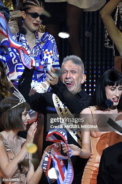 French designer Jean Paul Gaultier celebrates with models at the end of his last ready-to-wear collection, the 2015 Spring/Summer ready-to-wear...