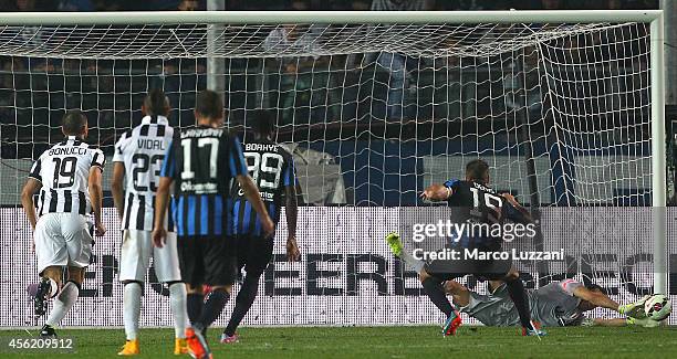 Gianluigi Buffon of Juventus FC saves a penalty-kick taken by German Gustavo Denis of Atalanta BC during the Serie A match between Atalanta BC v...