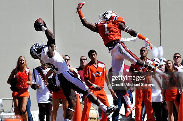 Cornerback Donald Celiscar of the Western Michigan Broncos catches an interception intended for wide receiver Isaiah Ford of the Virginia Tech Hokies...