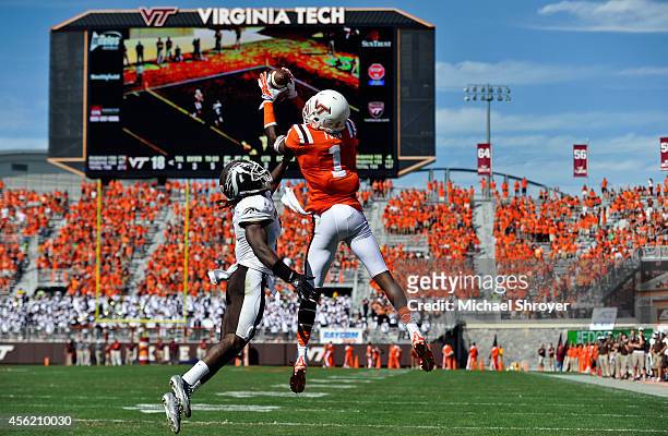 Wide receiver Isaiah Ford of the Virginia Tech Hokies makes a touchdown catch while being defended by cornerback Ronald Zamort of the Western...