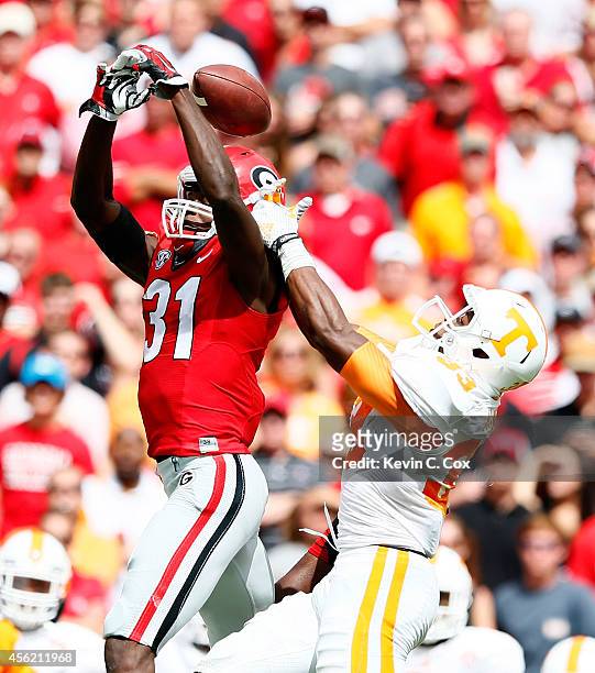 Chris Conley of the Georgia Bulldogs fails to pull in this reception against LaDarrell McNeil of the Tennessee Volunteers at Sanford Stadium on...