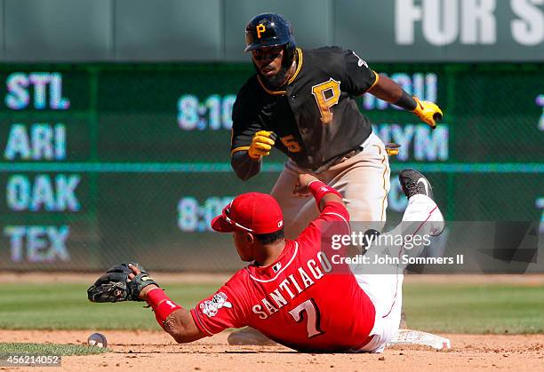 Josh Harrison of the Pittsburgh Pirates slides in safe ahead of the tag at second base by Ramon Santiago Cincinnati Reds at Great American Ball Park...