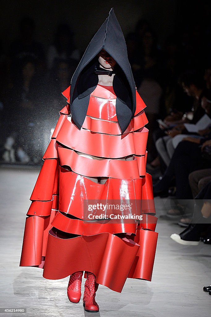 A model walks the runway at the Comme Des Garcons Spring Summer