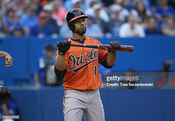 Alexi Casilla of the Baltimore Orioles reacts after striking out swinging in the eighth inning during MLB game action against the Toronto Blue Jays...