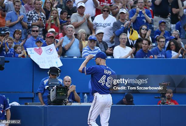 Happ of the Toronto Blue Jays salutes the fans as he is relieved in the seventh inning during MLB game action against the Baltimore Orioles on...