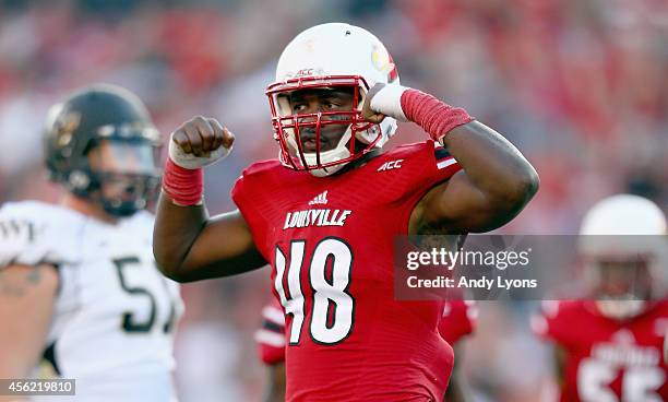 Deiontrez Mount of the Louisville Cardinals celebrates after sacking the quarterback during the game against the Wake Forest Demon Deacons at Papa...