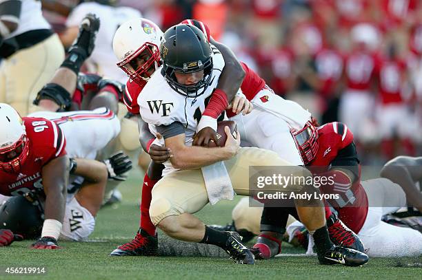 Deiontrez Mount of the Louisville Cardinals sacks John Wolford of the Wake Forest Demon Deacons during the game at Papa John's Cardinal Stadium on...