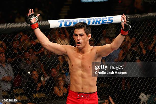 Dominick Cruz celebrates after his victory over Takeya Mizugaki in their bantamweight fight during the UFC 178 event inside the MGM Grand Garden...