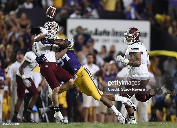 Adam Shapiro of the New Mexico State Aggies looses the ball while being hit by Danielle Hunter of the LSU Tigers during the first quarter of a game...