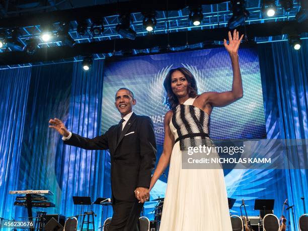 President Barack Obama and First Lady Michelle Obama acknowledge the crowd after he spoke at the Congressional Black Caucus Foundation's 44th Annual...