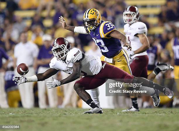 Rayvean Moore of the New Mexico State Aggies reaches for a pass in front of Jamal Adams of the LSU Tigers during the third quarter of a game at Tiger...