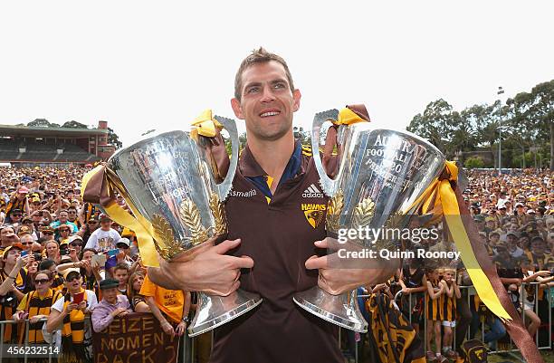 Luke Hodge the captain of the Hawks poses with the 2013 and 2014 AFL Premeirship Cups at the Hawthorn Hawks AFL team celebration at Glenferrie Oval...