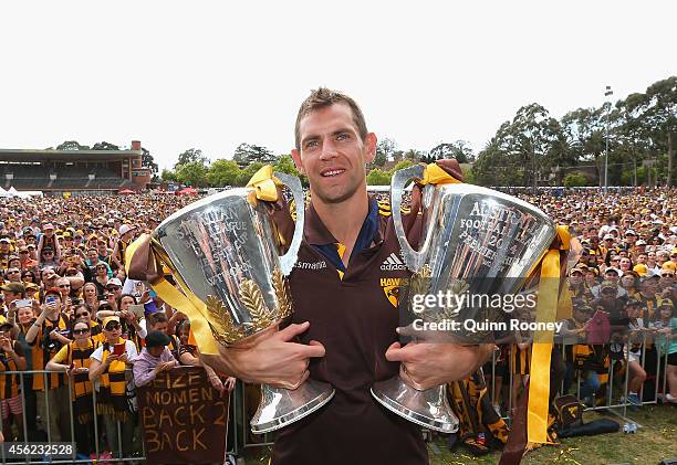 Luke Hodge the captain of the Hawks poses with the 2013 and 2014 AFL Premeirship Cups at the Hawthorn Hawks AFL team celebration at Glenferrie Oval...