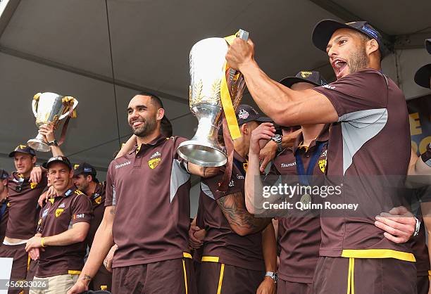 Shaun Burgoyne and Josh Gibson of the Hawks hold up the Premeirship Cup to the crowd at the Hawthorn Hawks AFL team celebration at Glenferrie Oval on...